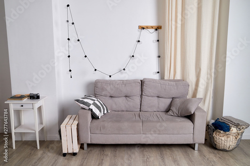 Quadro em tela Interior of a modest living room with a sofa