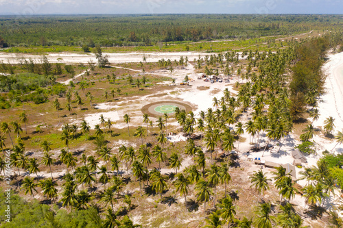 Helipad on a tropical island. Balabac, Palawan, Philippines. Helipad among the palm trees on a tropical island, top view. photo