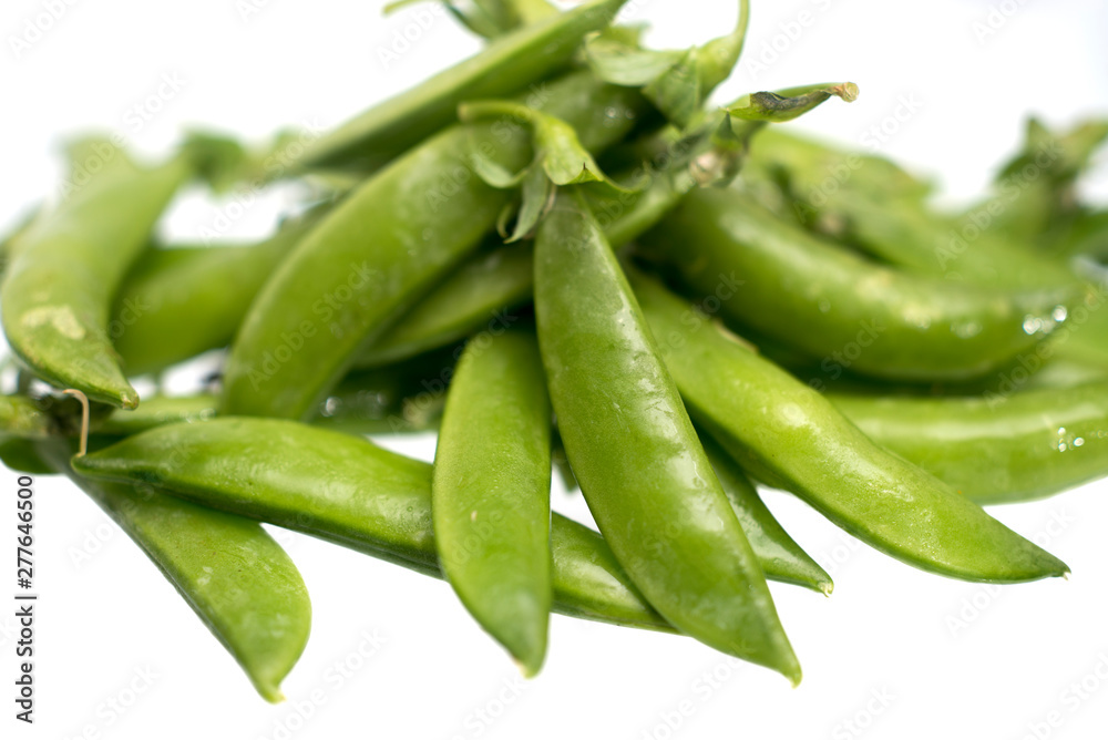 Closeup pile of fresh green beans isolated on a white background Closeup pile of fresh green beans isolated on a white background