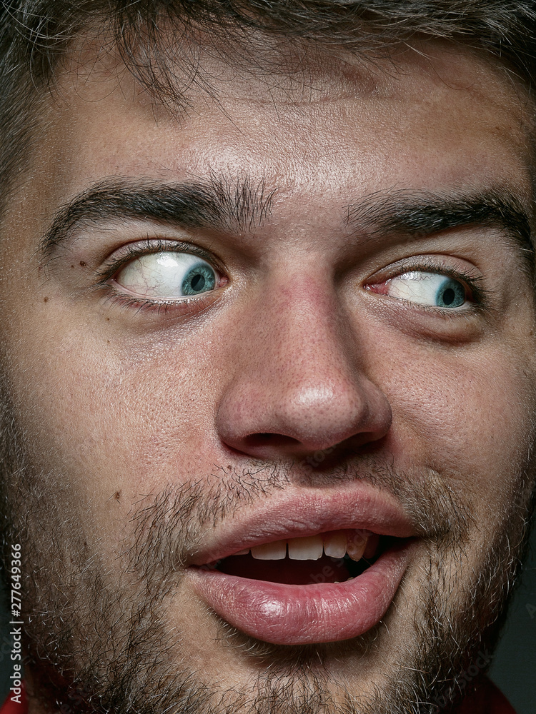 Close up portrait of young and emotional caucasian man. Highly detail photoshot of male model with well-kept skin and bright facial expression. Concept of human emotions. Looks playful. Close up portrait of young and emotional caucasian man. Highly detail photoshot of male model with well-kept skin and bright facial expression. Concept of human emotions. Looks playful.