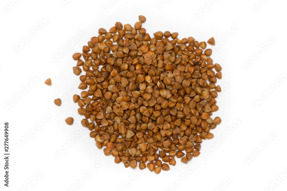 Buckwheat grains scattered on a white background Buckwheat grains scattered on a white background
