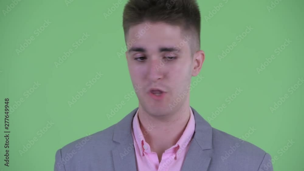 Face of serious young businessman nodding head no Face of serious young businessman nodding head no