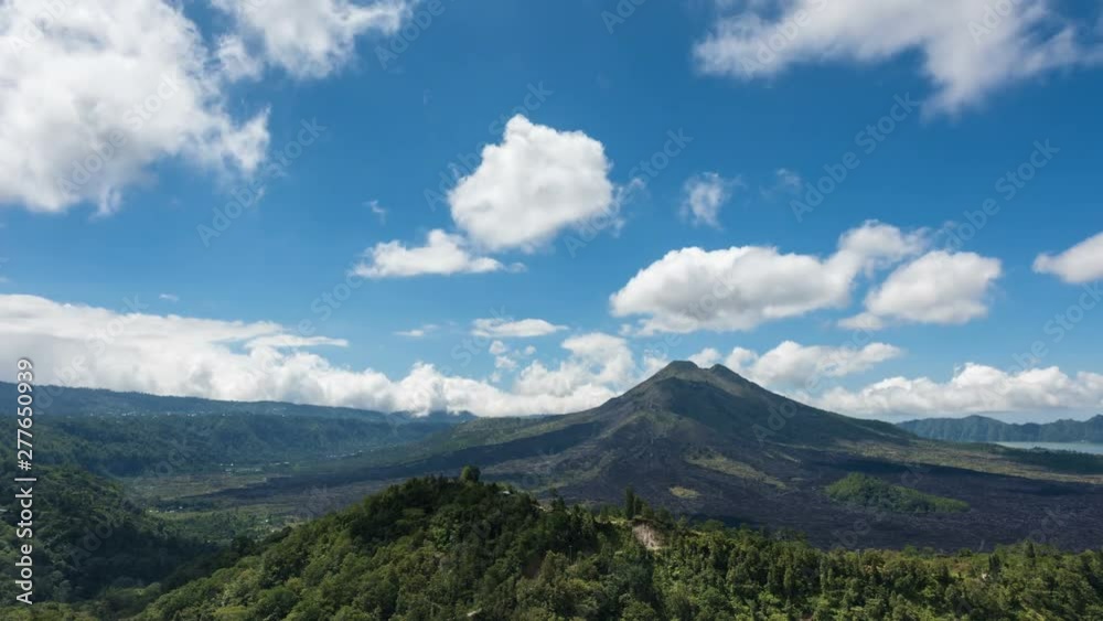 time lapse of mount agung volcano against a blue sky, it is the highest mountain in Bali, Indonesia time lapse of mount agung volcano against a blue sky, it is the highest mountain in Bali, Indonesia