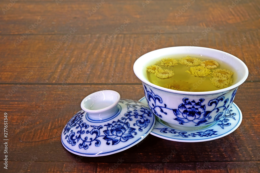 Chrysanthemum tea. Chinese tradition chrysanthemum tea in beautiful blue and white porcelain cup, famous herbal tea from Huangshan , Anhui China. Selective focus, copy space.