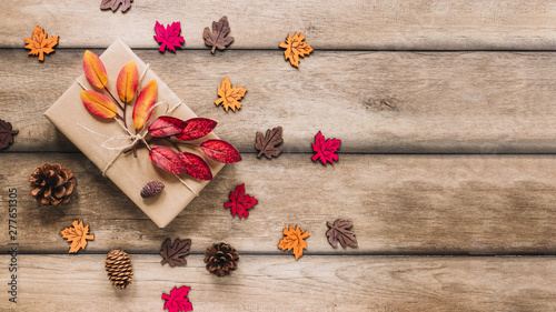 Multicolourful leaves around carton box photo