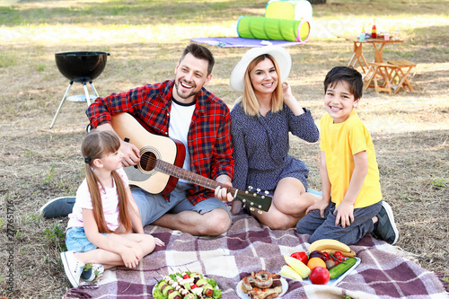 Happy family having picnic ...