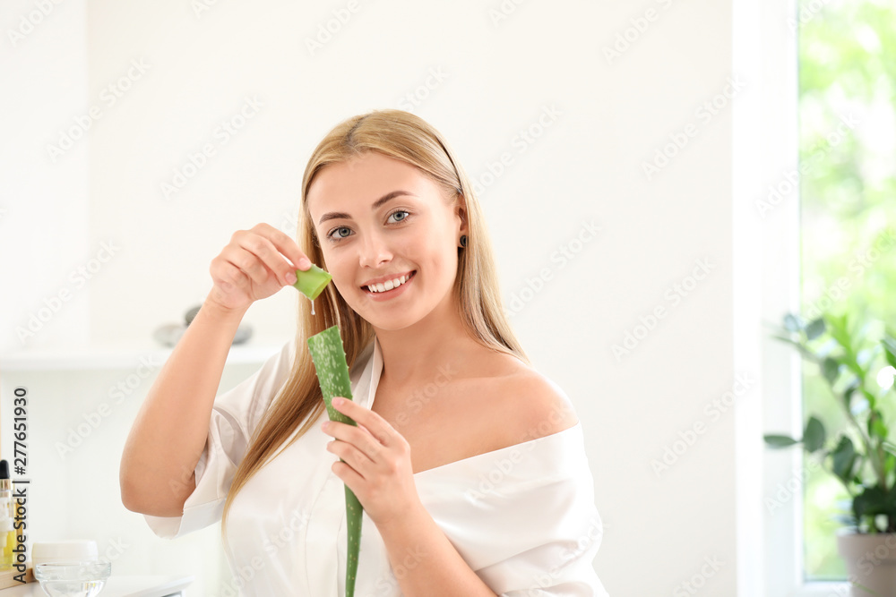 Beautiful young woman using aloe vera at home Beautiful young woman using aloe vera at home