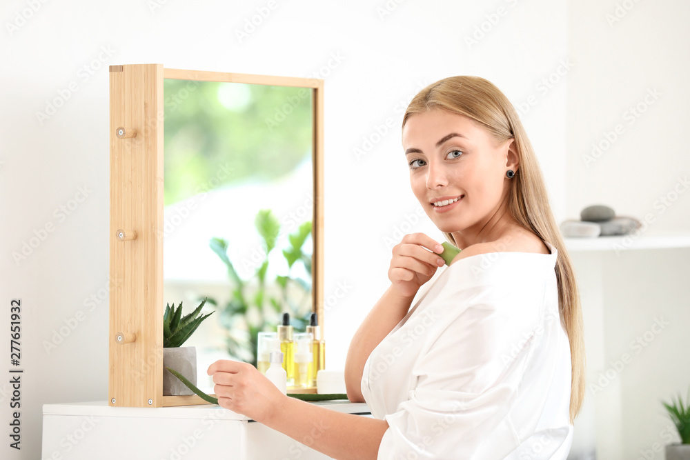 Beautiful young woman using aloe vera at home Beautiful young woman using aloe vera at home