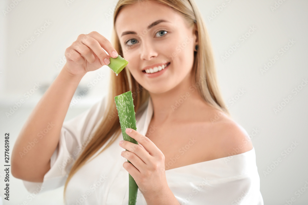 Beautiful young woman using aloe vera at home Beautiful young woman using aloe vera at home