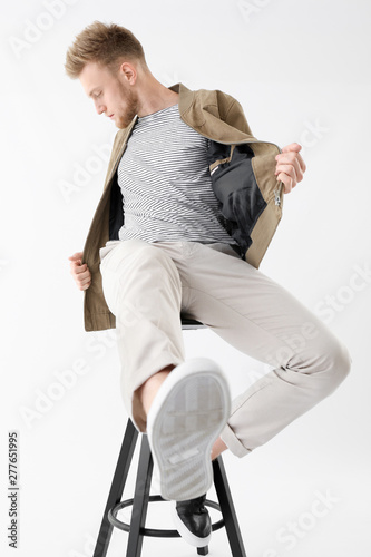 Stylish young man sitting o...