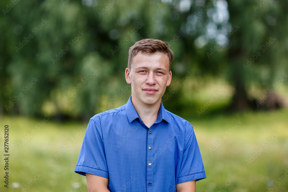 the guy in the blue shirt outdoors on a summer day