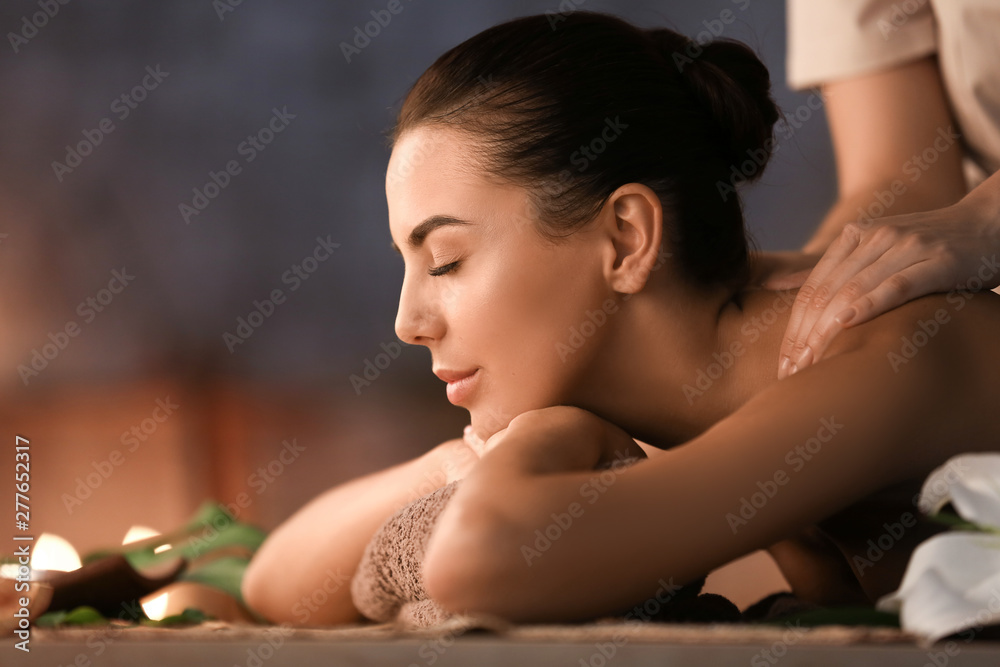 Beautiful young woman receiving massage in spa salon - obrazy, fototapety, plakaty 