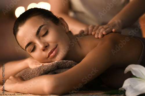 Canvastavla Beautiful young woman receiving massage in spa salon