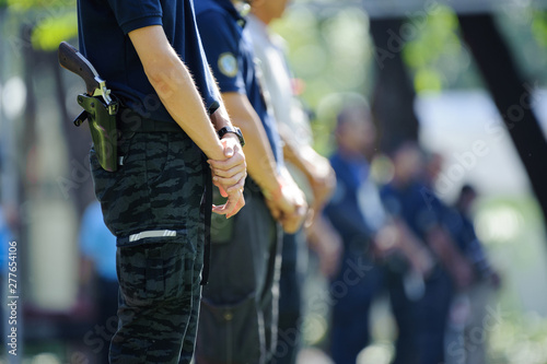 Shooters standing in a row, ready to shoot with a revolver handgun. Basic handgun shooting class