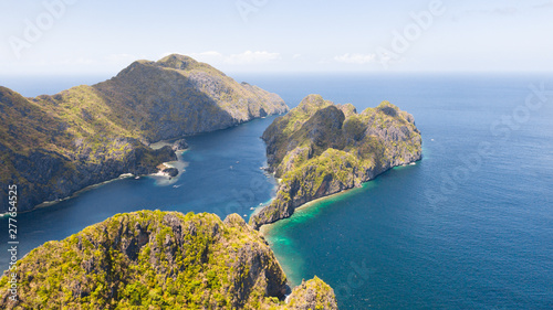 Seascape with tropical islands. El Nido Palawan National Park Philippines. Rocky islands covered with forest. Small lagoons with white beaches. Boat tours between the islands.