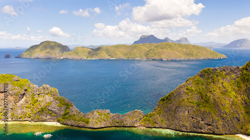 Seascape with tropical islands. El Nido Palawan National Park Philippines. Rocky islands covered with forest. Small lagoons with white beaches. Boat tours between the islands.