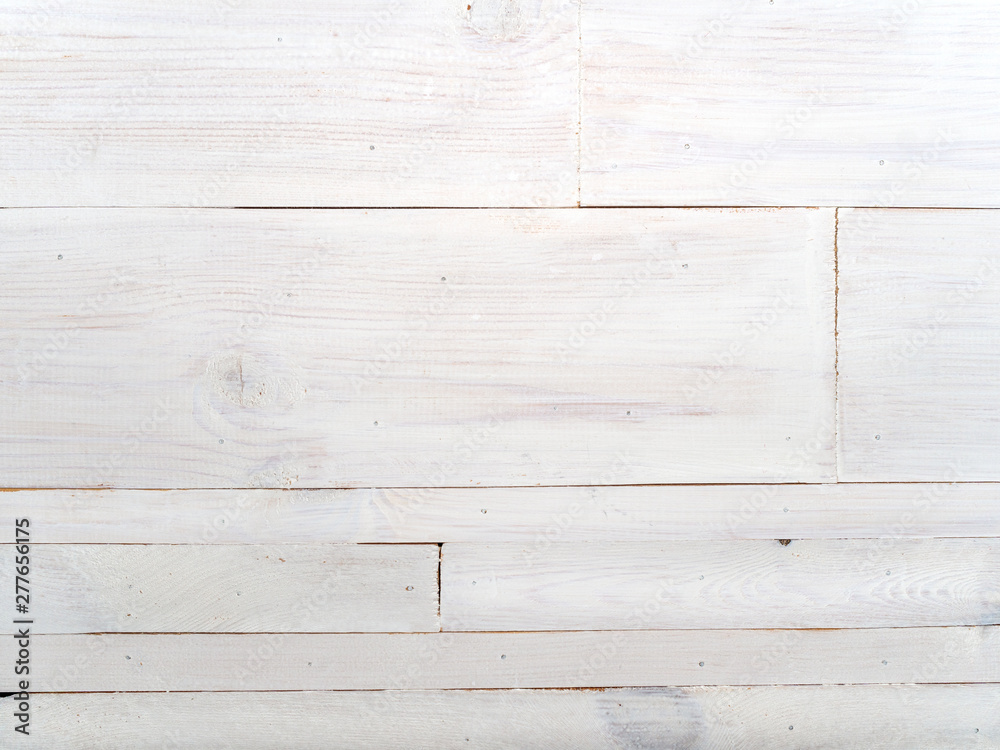 Naklejka premium Wooden table made of various sizes boards painted in white. Background with horizontal lines