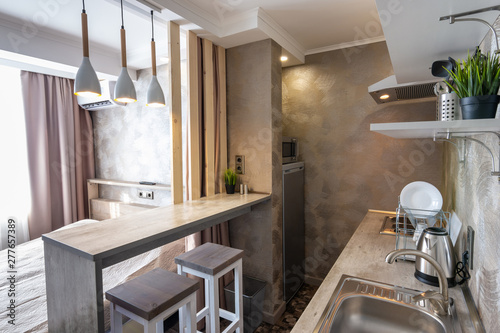 View of the kitchen and bar in a small hotel room - studio