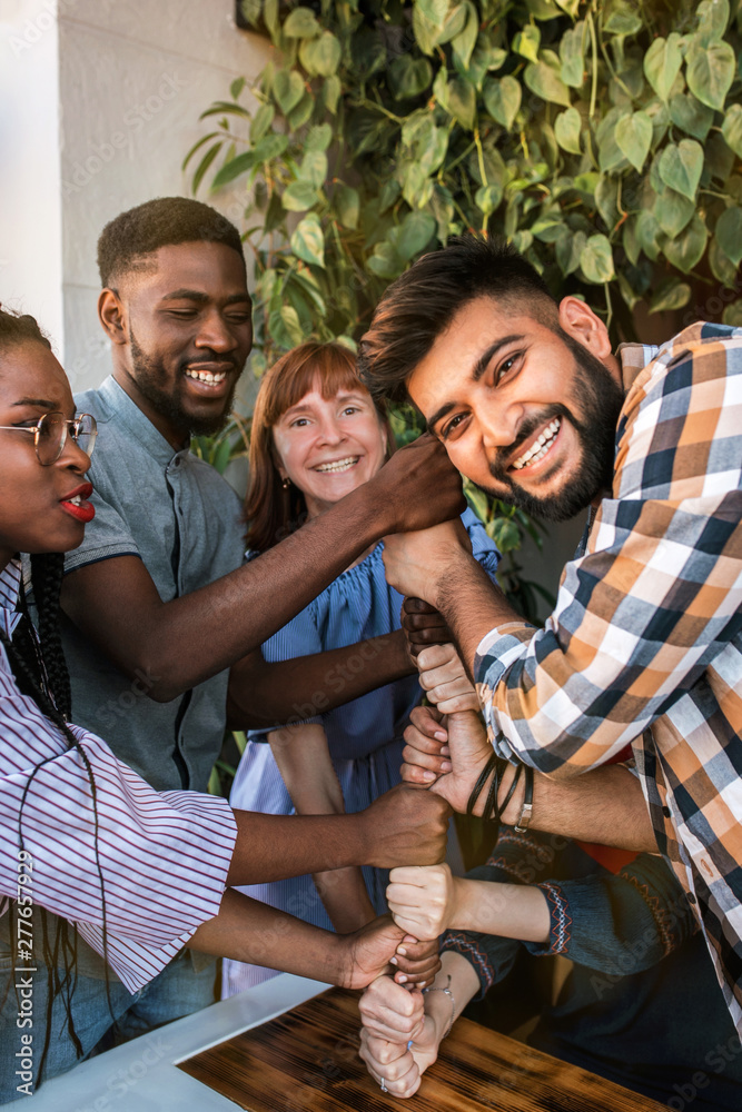 Group of happy multiracial friends thumbs up together. Group of happy multiracial friends thumbs up together.