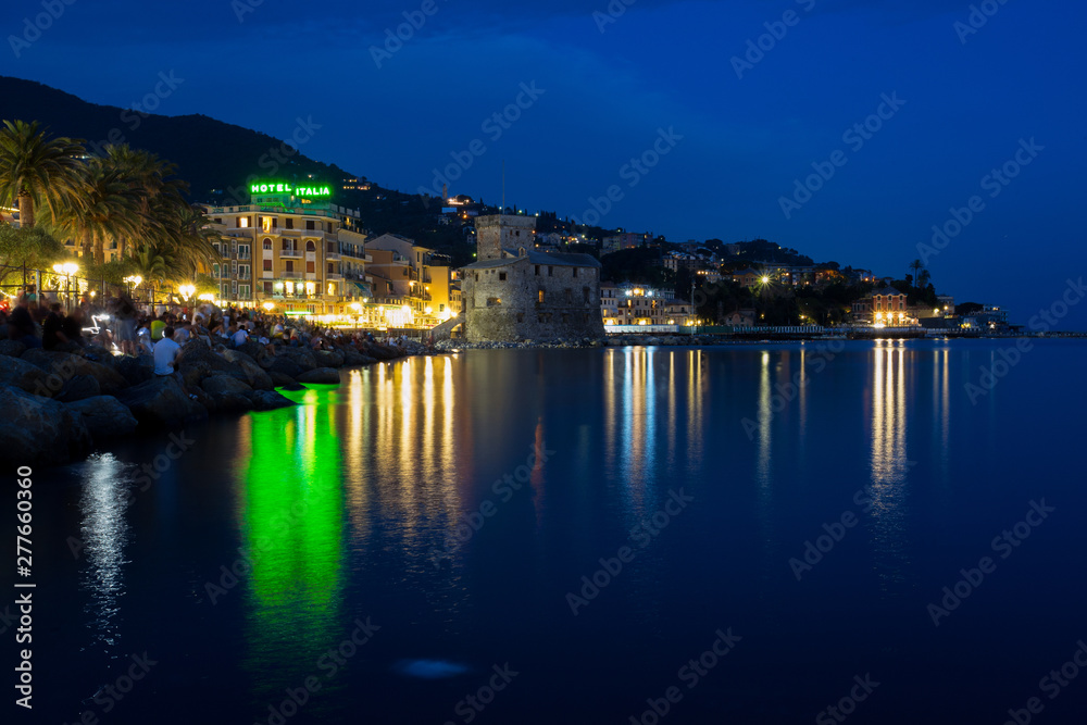 RAPALLO, ITALY JULY, 3, 2019 - View of Rapallo, Genoa (Genova) province and the castle on the sea by night, Italy.