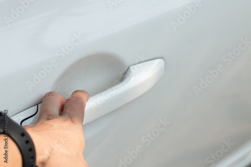 Close up of human male hand opening car door 