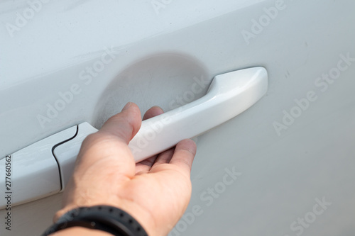 Close up of human male hand opening car door 