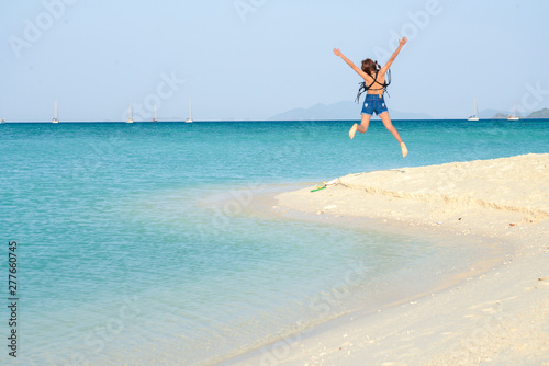 Portrait of young pretty woman at the turquoise sea beach, Lipe island, Thailand