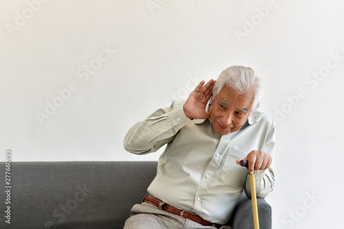 Hearing loss problem, Asian old man with hand on ears gesture trying to listen, Aging senior decline in hearing ability, Elderly health problems concept.