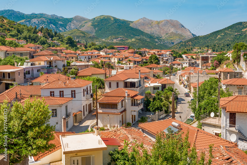 Summer day in mountain town. Traveling concept. Vacation background. Greek island of Euboea island, Greece. Greek old city, down town. View of Kimi, Greece. Amazing Skopelos old town by day