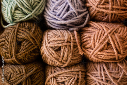 Selection of colorful yarn wool on shopfront.