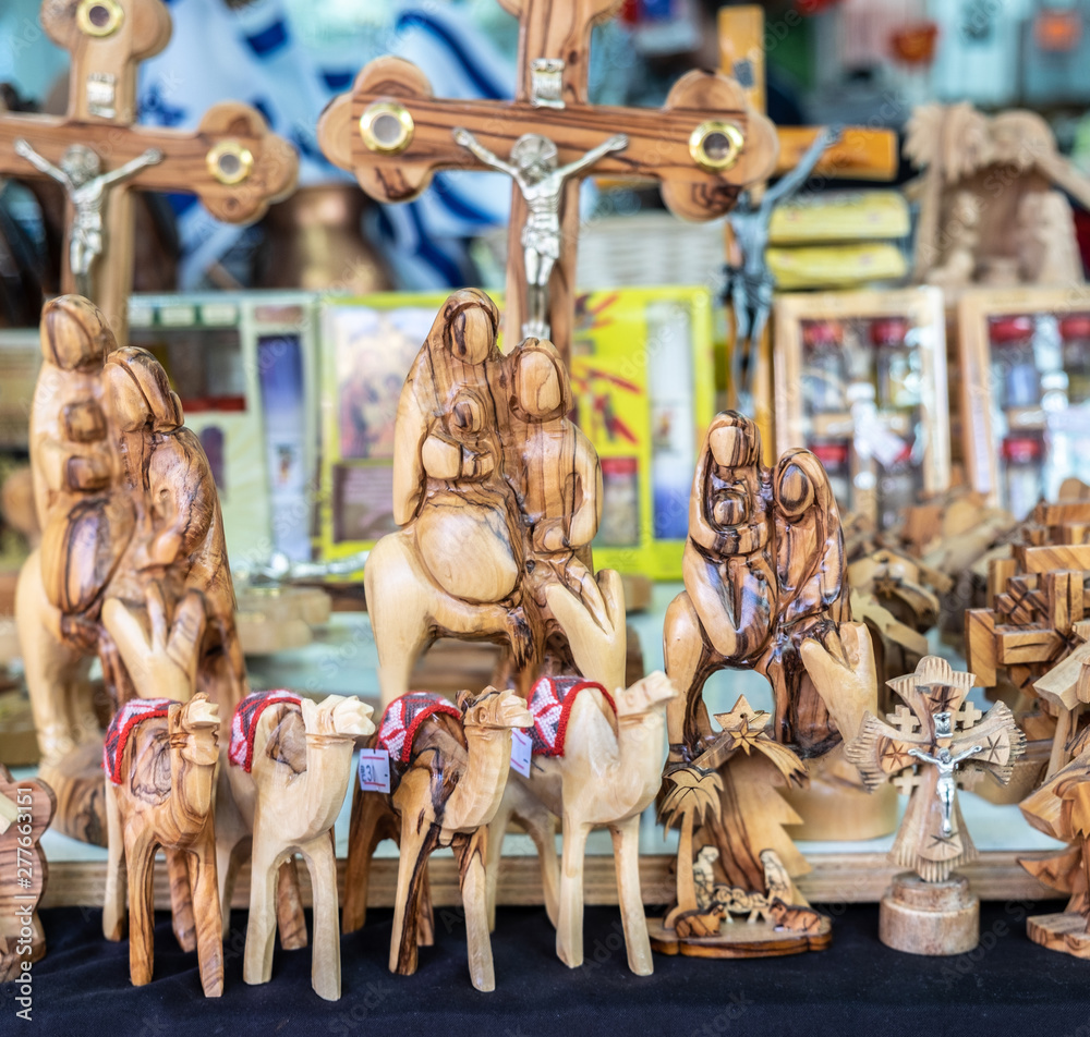 Naklejka premium Olive wood handmade christian symbolism sold at street market