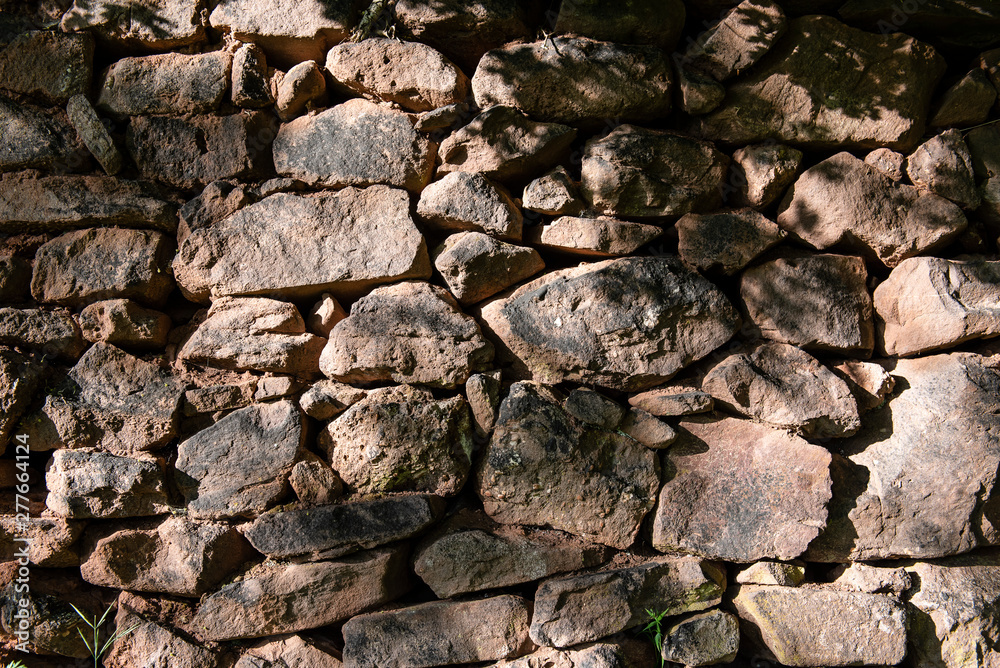 Handmade stone wall made of big rock chunks.