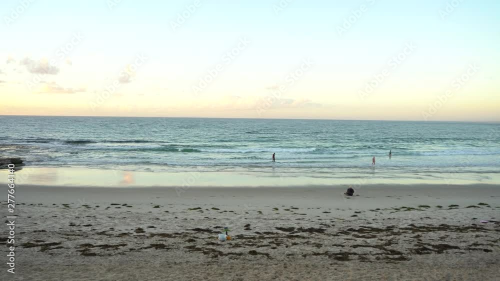 very wide shot of people on the beach during sunrise filmed at Australia, Queensland, Sunshine Coast, Caloundra, Kings Beach very wide shot of people on the beach during sunrise filmed at Australia, Queensland, Sunshine Coast, Caloundra, Kings Beach