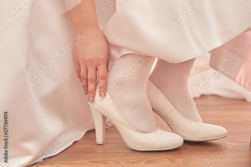 female feet in white shoes © Иван Волков