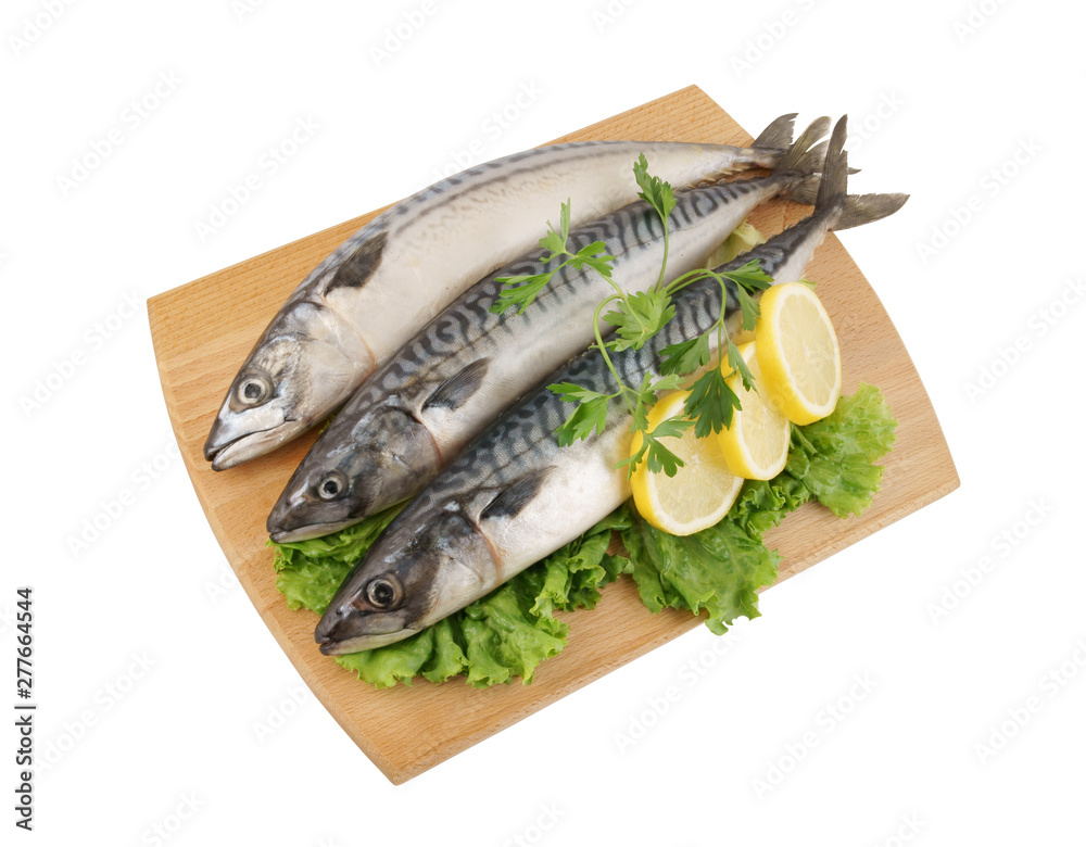Mackerel fish with greens and lemon on wooden board isolated Mackerel fish with greens and lemon on wooden board isolated