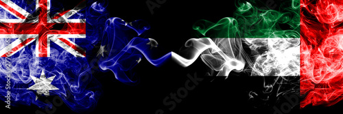 Australia vs United Arab Emirates, Emirati smoky mystic flags placed side by side. Thick colored silky smokes combination of national flags of Australia and United Arab Emirates, Emirati photo