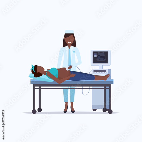 african american pregnant woman visiting doctor doing ultrasound fetus screening at digital monitor gynecology consultation healthcare concept modern hospital equipment flat full length