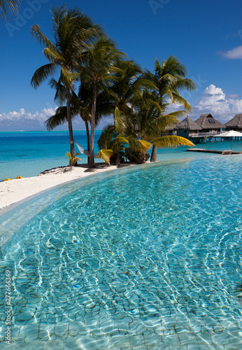 Fototapeta Naklejka Na Ścianę i Meble -  The pool under palm trees on the seashore.Polynesia, Tahiti