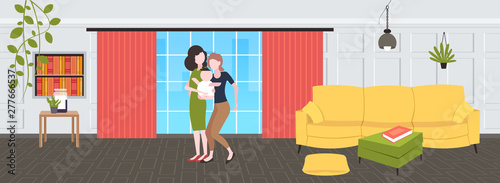 two young mothers lesbians holding newborn baby son lgbt lesbian same sex couple with boy happy family having fun modern living room interior flat full length horizontal