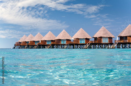 houses over transparent quiet sea water- tropical paradise  Maldives