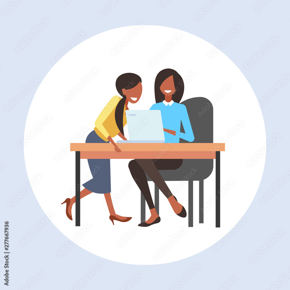 businesswomen coworkers sitting at workplace desk two african american business women using laptop working process teamwork concept flat full length businesswomen coworkers sitting at workplace desk two african american business women using laptop working process teamwork concept flat full length