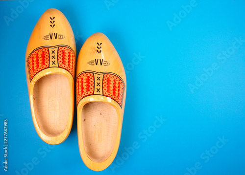 Fotografie Holland, Netherlands, Amsterdam clogs typical Dutch on blue background with copy