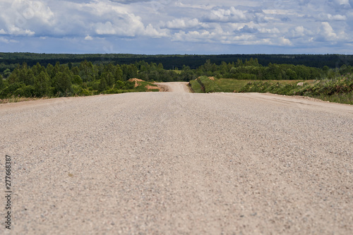 Wide gravel road going to the horizon