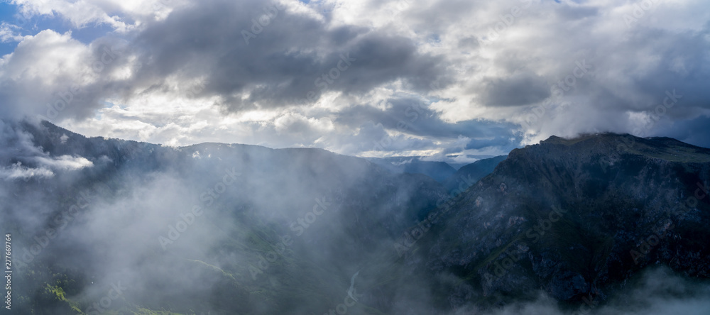 Montenegro, XXL nature landscape panorama of tara river canyon inside durmitor national park near zabljak from above at dawn in misty mystic rainy atmosphere and light
