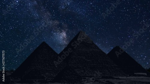 pyramids in silhouette with time lapse of stars