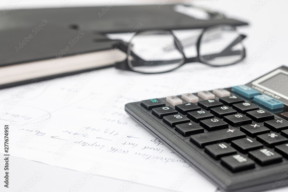 calculator and documents for working on the table, Finance and savings, Business concept. calculator and documents for working on the table, Finance and savings, Business concept.