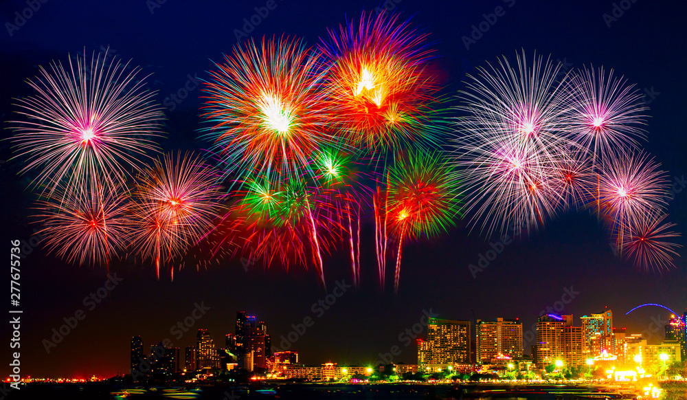 Fototapeta premium Beautiful colorful fireworks display on the sea beach, Amazing holiday fireworks party or any celebration event in the dark sky.