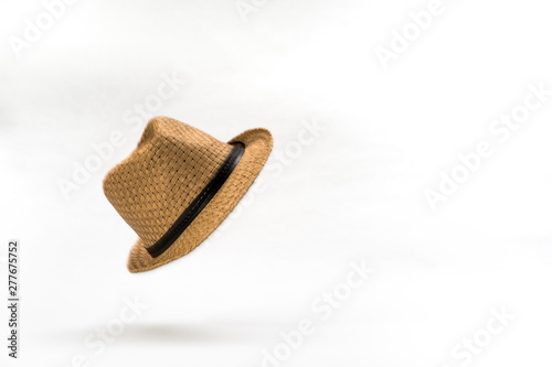 At the Drop of a Hat. A straw panama hat falling against a white background. photo