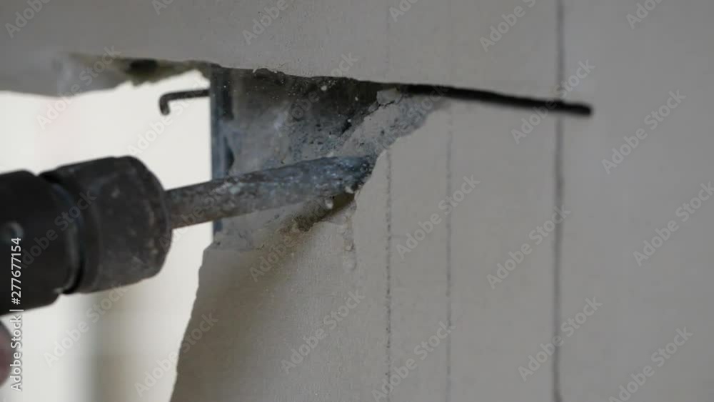 Close-up builder worker with pneumatic hammer drill equipment breaking asphalt at construction site. slow motion Close-up builder worker with pneumatic hammer drill equipment breaking asphalt at construction site. slow motion