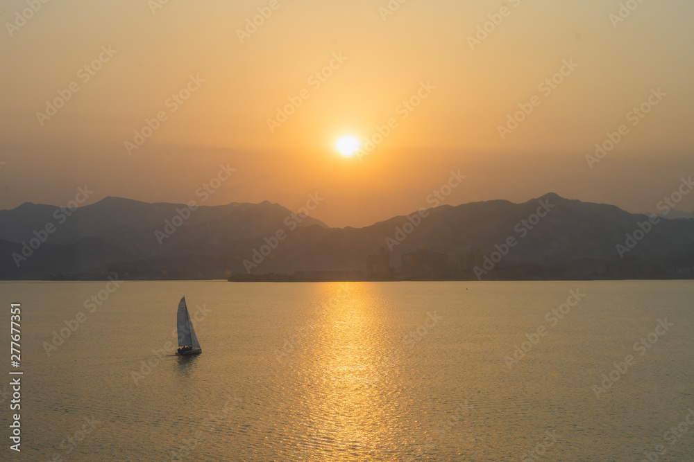 Sailing boats on the lake at sunset